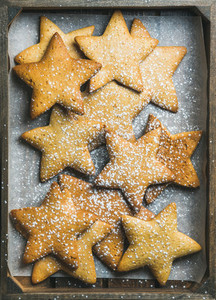 Christmas gingerbread cookies in shape of stars with sugar powder