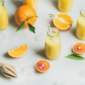 Healthy yellow smoothie with citrus fruit  square crop