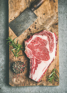 Raw prime beef meat dry aged steak rib eye and chopping knife