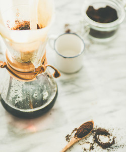 Black filtered coffee in Chemex on grey marble table background