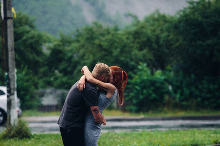 beautiful couple hugging in the rain