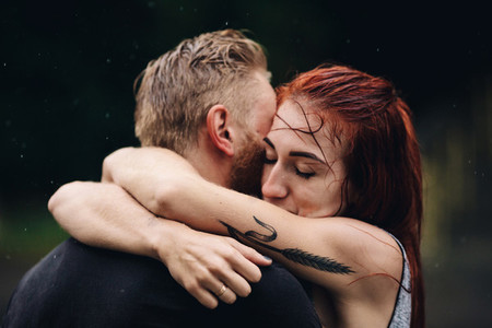 beautiful couple hugging in the rain
