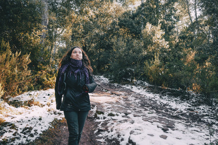 Girl fooling around on a snowy mountain road
