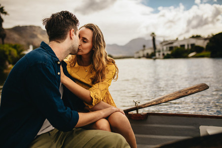 Couple kissing on a boat