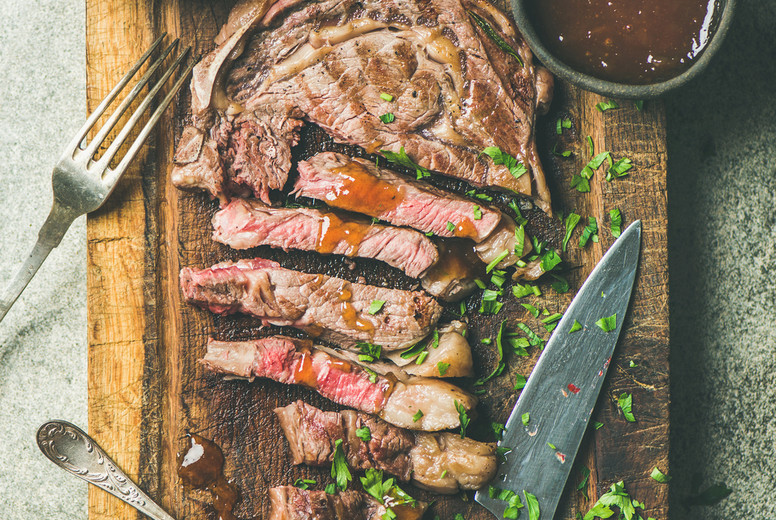 Flat-lay of grilled medium rare ribeye beef steak