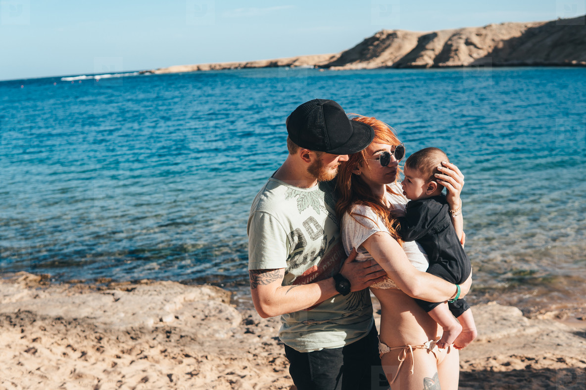 Parents playing with their little son