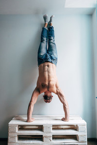 Man posing on camera standing upside down