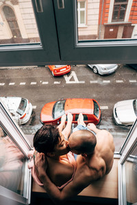 Man and beautiful girl while sitting by the window