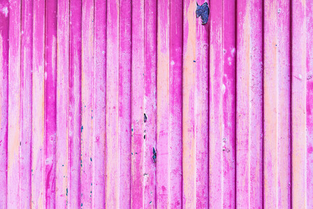 Pink rusted metal door with peeling paint