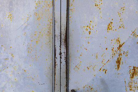 Blue rusted metal door with peeling paint