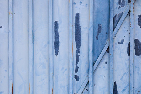 Blue rusted metal door with peeling paint