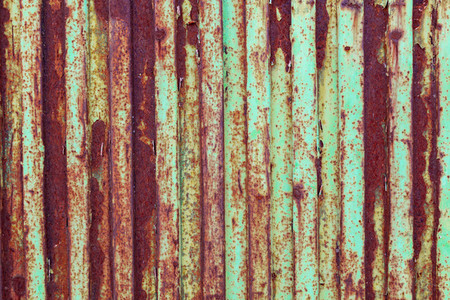 Green rusted metal door with peeling paint