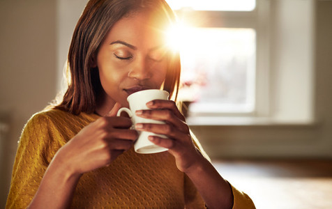 Attractive woman enjoying a cup of fresh coffee