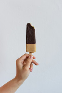 Holding chocolate popsicle
