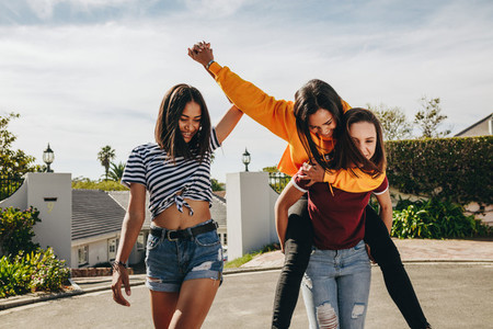 Three girl friends playing in the street