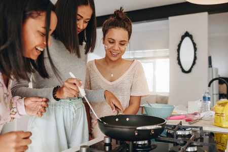 Teenage girls trying their hand at cooking