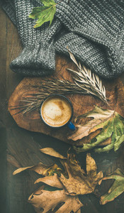 Autumn morning coffee concept with leaves and sweater  vertical composition