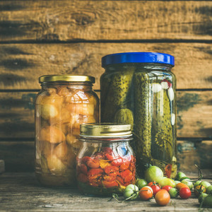 Autumn pickled vegetables in glass jars  copy space  square crop