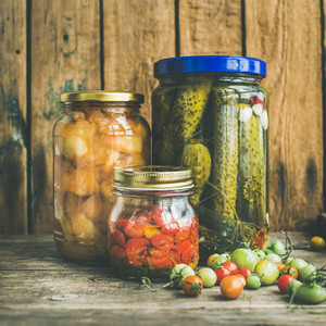 Autumn seasonal pickled vegetables and fruit in jars  square crop