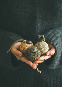 Woman holding golden and silver balls in hands  vertical composition