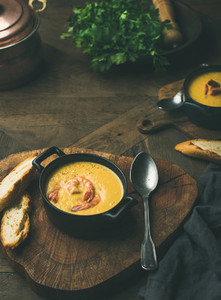 Corn creamy soup with shrimps served in individual pots