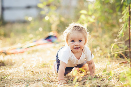little girl crawling on the lawn