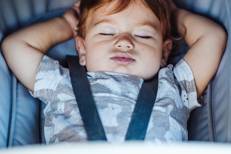 Little baby sleeping in a stroller.