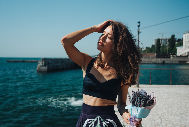 Young pretty woman on the pier near