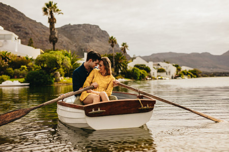 Couple enjoying their boat date in a lake
