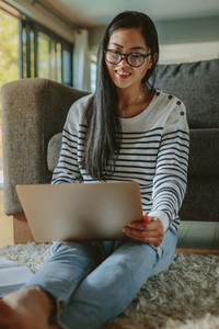 Student studying at home with laptop