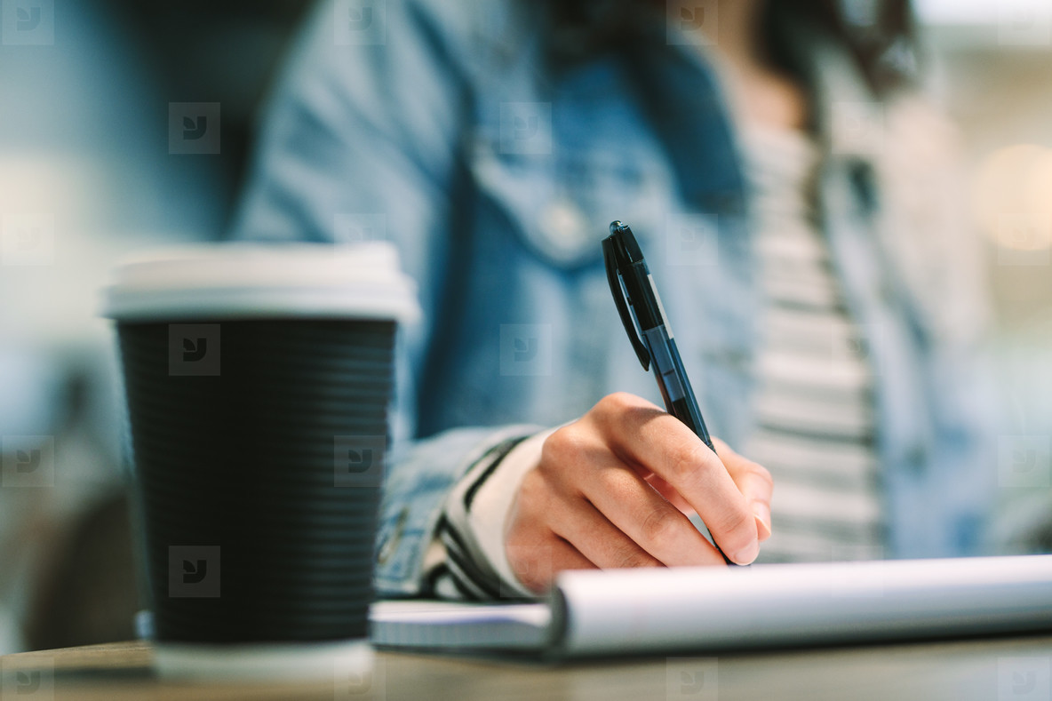 Close up of female student making notes