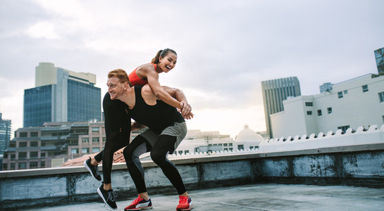 Fitness couple having fun while training on rooftop