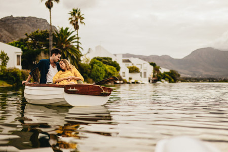 Couple sitting together in a boat relaxing on a date