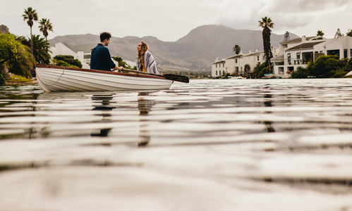 Couple enjoying their boat date in a lake