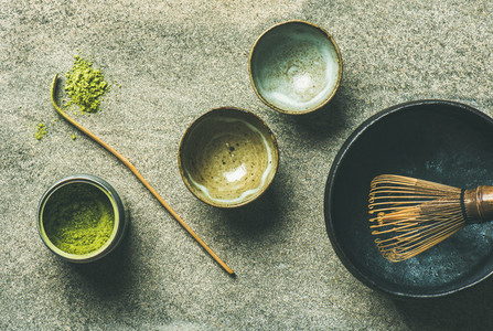 Japanese tools for brewing matcha tea  grey background  top view