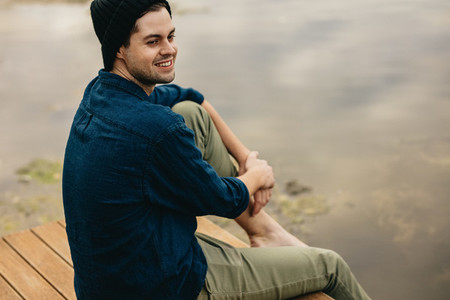 Man on a holiday sitting near a lake