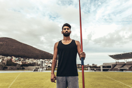 Athlete standing holding a javelin