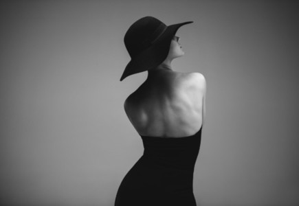 Elegant woman in black dress and hat