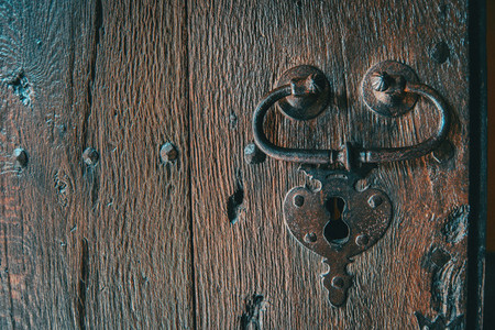 Detail of a lock and a handle of a wooden medieval door
