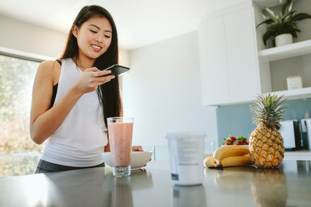 Woman taking picture of her nutritious breakfast