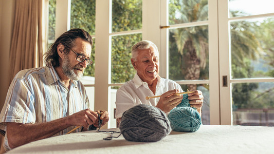 Senior people learning knitting
