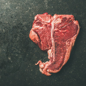 Close up of fresh raw beef meat porterhouse steak copy space