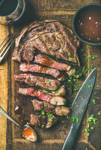 Grilled medium rare ribeye beef steak with red wine  flat lay