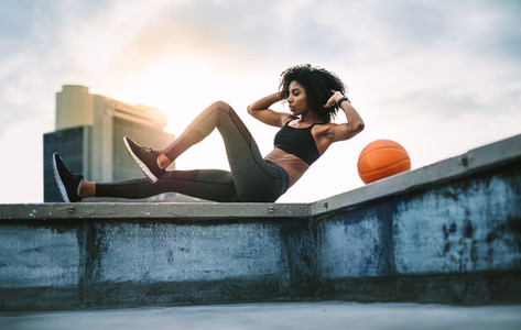 Fitness woman doing workout on rooftop