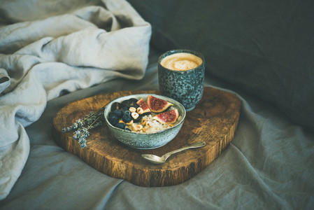 Rice coconut porridge with figs  berries and hazelnuts and coffee