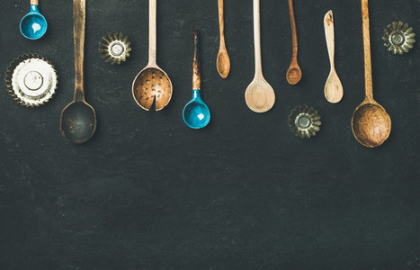 Flat lay of old vintage kitchen spoons and baking tin molds