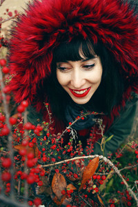 Portrait of a beautiful young brunette woman in red with a smile