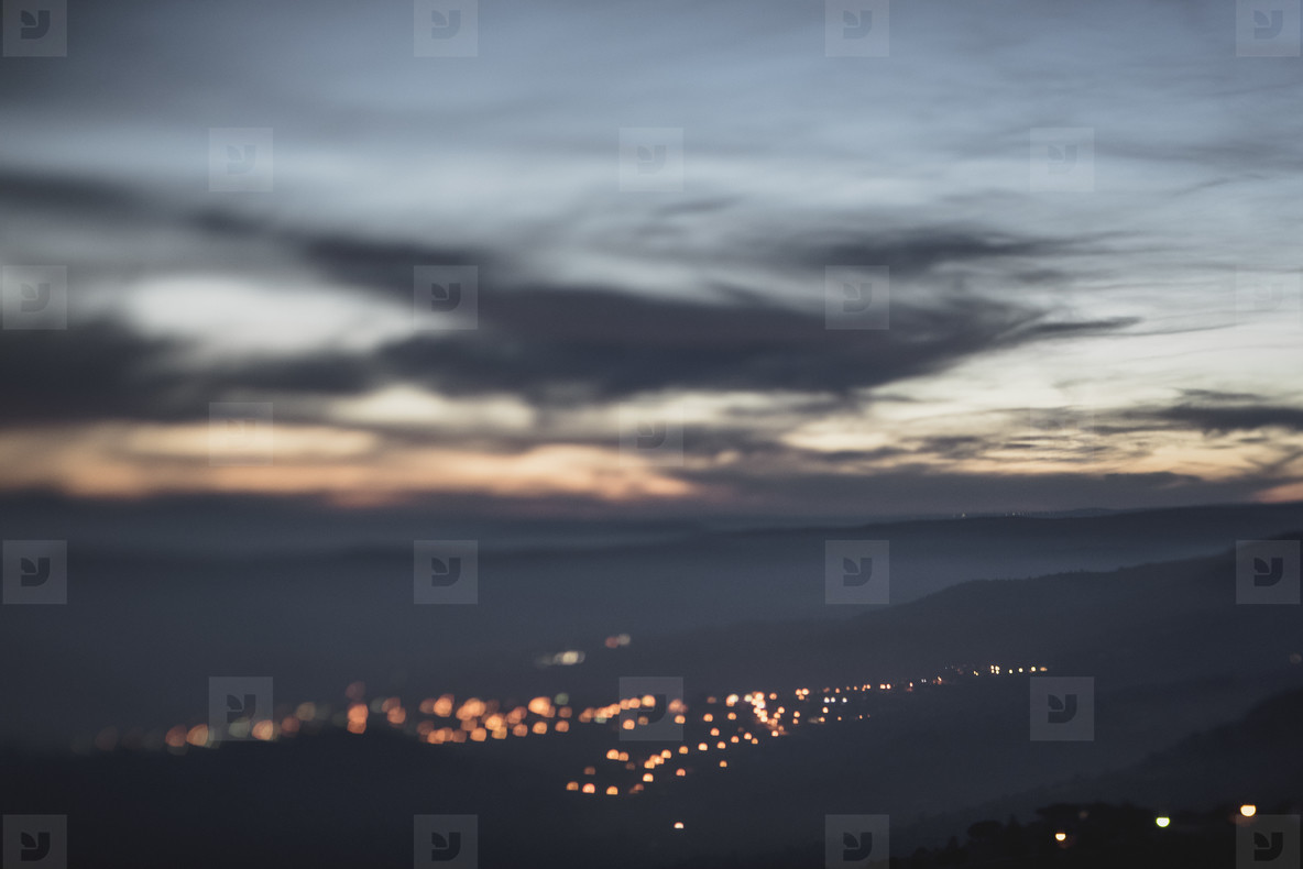 Blurry bokeh lights in dusk mountains