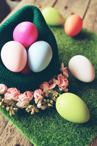 A beautiful and colorful close up of easter eggs in a wool baske