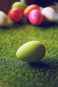 A beautiful and colorful close up of green easter egg over green